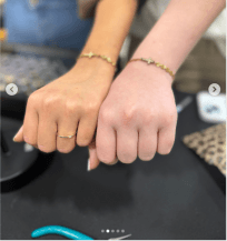 Design placeholder: close-up of gold permanent jewelry chains on a wrist. Direction reference only, not a cleared production photograph.